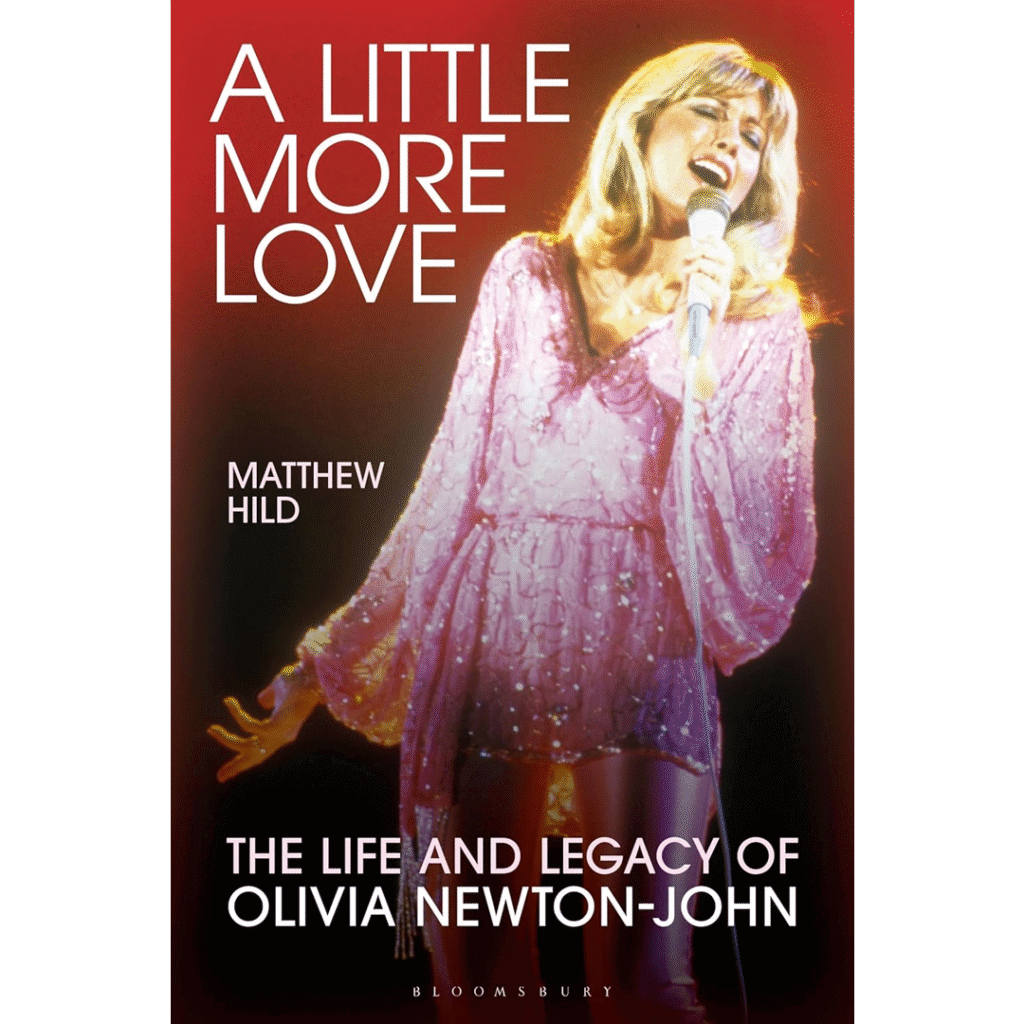 Cover of the book "A Little More Love" by Matthew Hild. It features a woman in a shimmering pink outfit singing passionately into a microphone, set against a red gradient background. The title and author's name are displayed in bold white text.