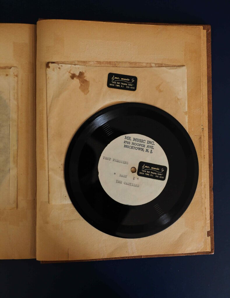 A vintage vinyl record displayed on a worn album page. The label reads "Mr. Music Inc.," conveying a nostalgic and historic tone.