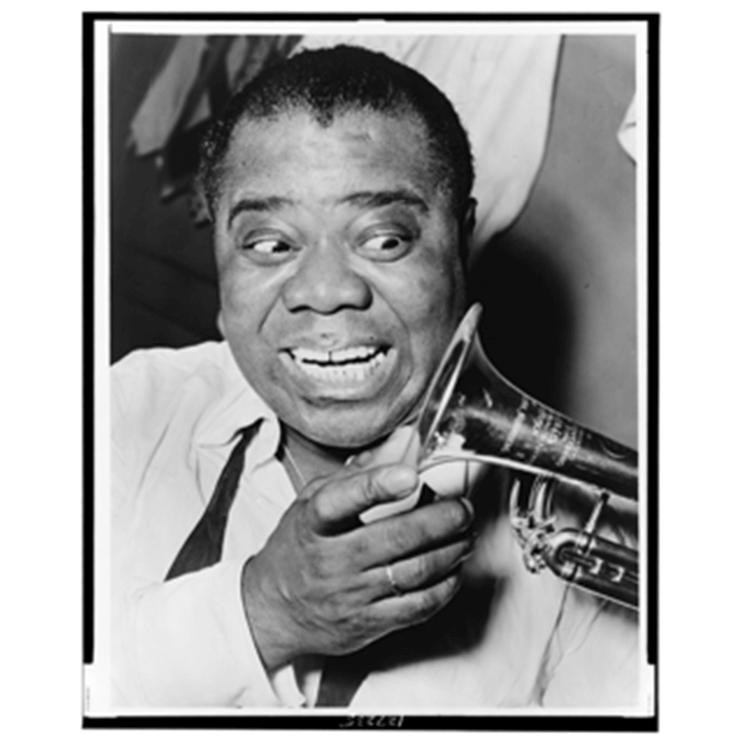 A joyful man holds a trumpet close to his face, displaying an energetic expression. He wears a light shirt with a dark suspenders. The mood is lively and vibrant.