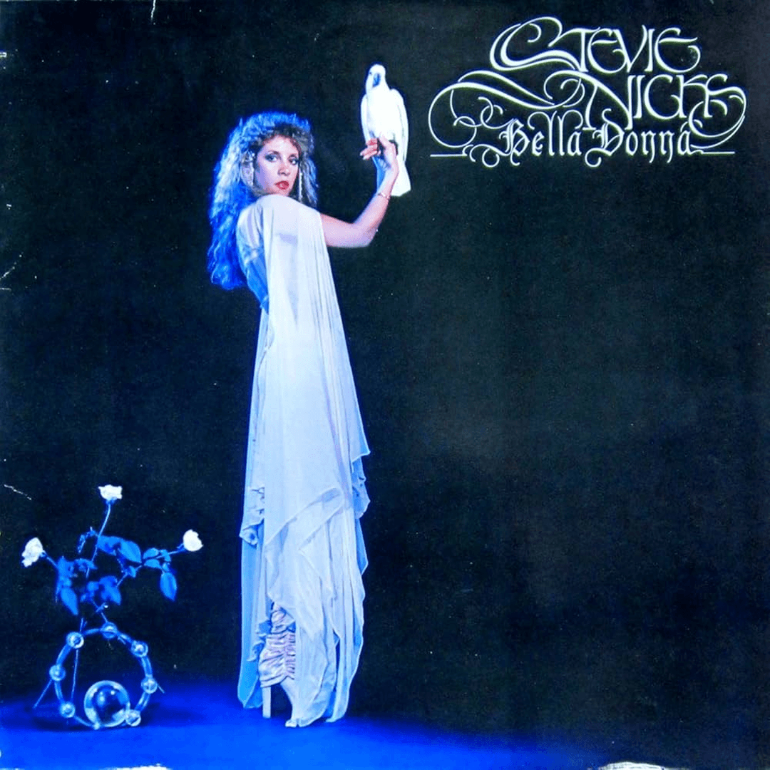 Iconic album cover for Stevie Nicks' debut solo album, Bella Donna, featuring the artist wearing a flowing gown and holding a white cockatoo against a dark background.