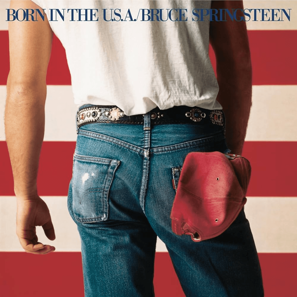 The iconic album cover for Bruce Springsteen's Born in the U.S.A., featuring a photograph of the artist from behind, wearing a white t-shirt, jeans, and a red baseball cap tucked into his back pocket, all set against the backdrop of the American flag.
